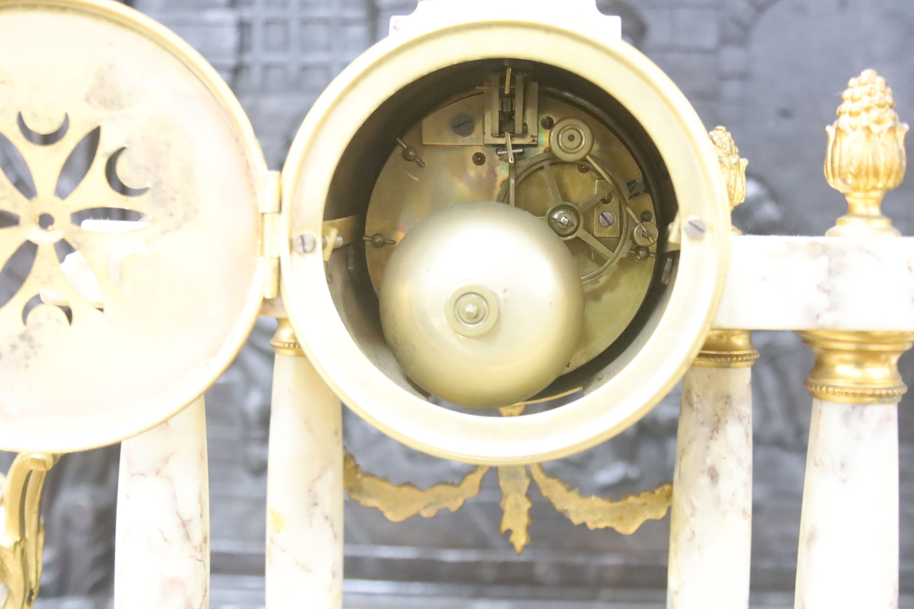 A late 19th century French three piece clock set, in Louis XVI taste with key and pendulum 42cm